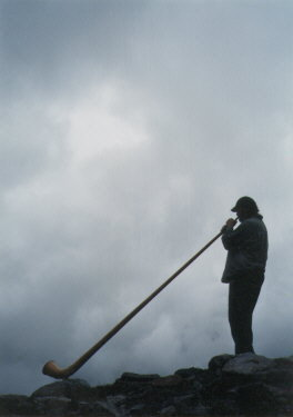 Photo: Playing Alphorn in the Mountain Mist